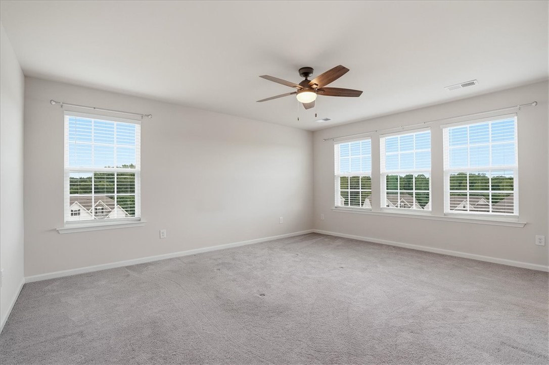 365 Sliding Rock Drive Pendleton, SC 29670 - Photo 26 of 46 A spacious and inviting room features multiple windows for abundant light and a ceiling fan for comfort.