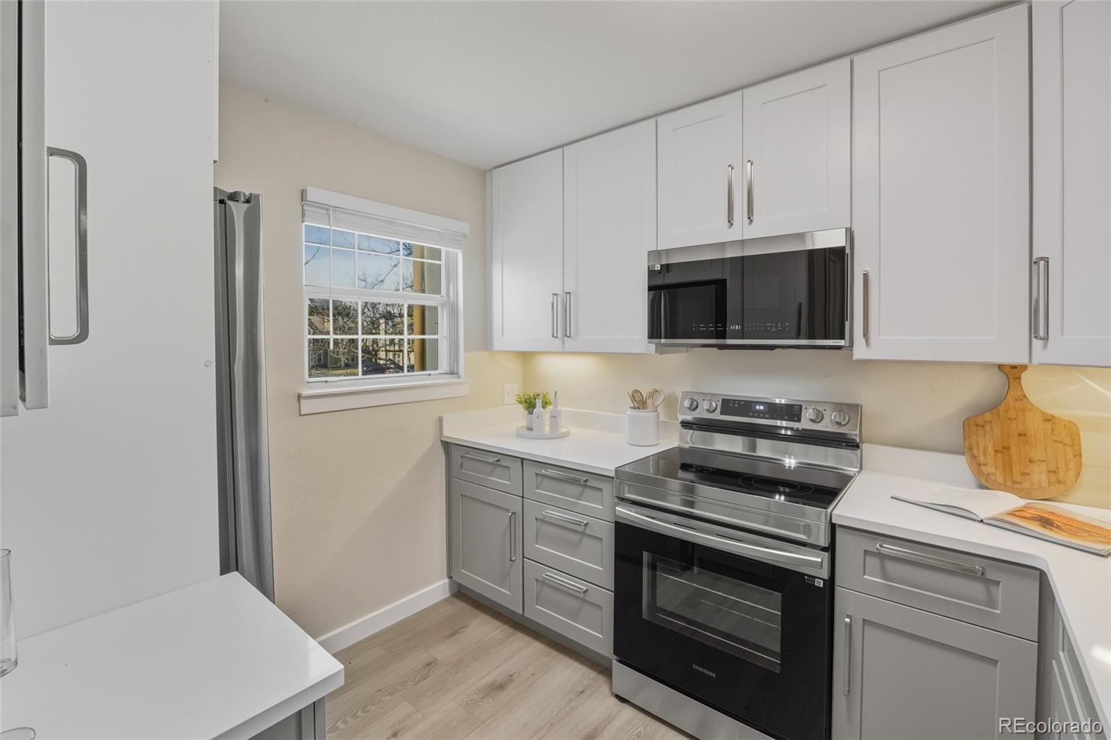 1811 South Quebec Way, Unit 82 Denver, CO 80231 - Photo 11 of 35 a kitchen with cabinets stainless steel appliances and a counter space