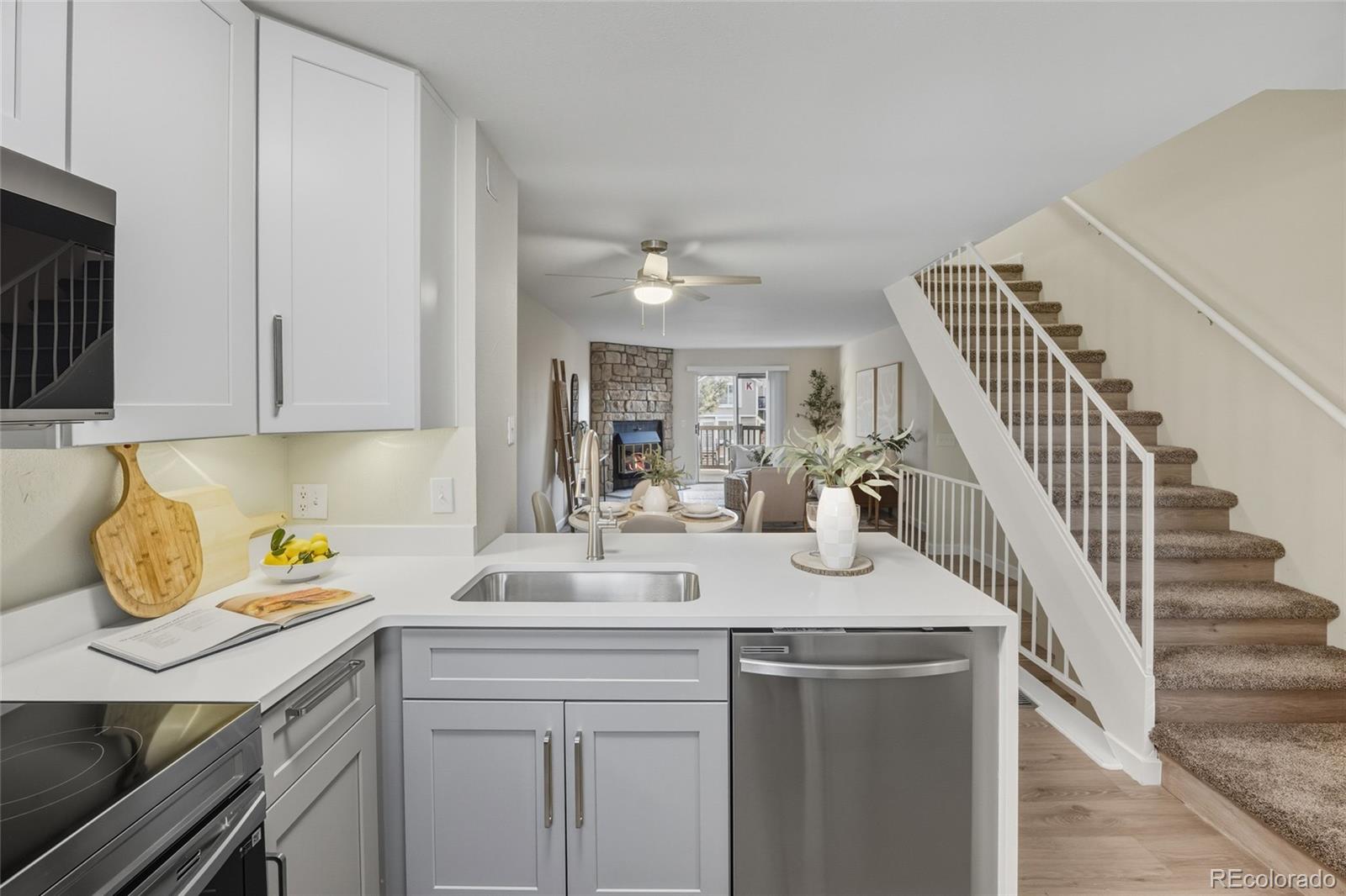 1811 South Quebec Way, Unit 82 Denver, CO 80231 - Photo 12 of 35 a kitchen with granite countertop a sink a stove and cabinets