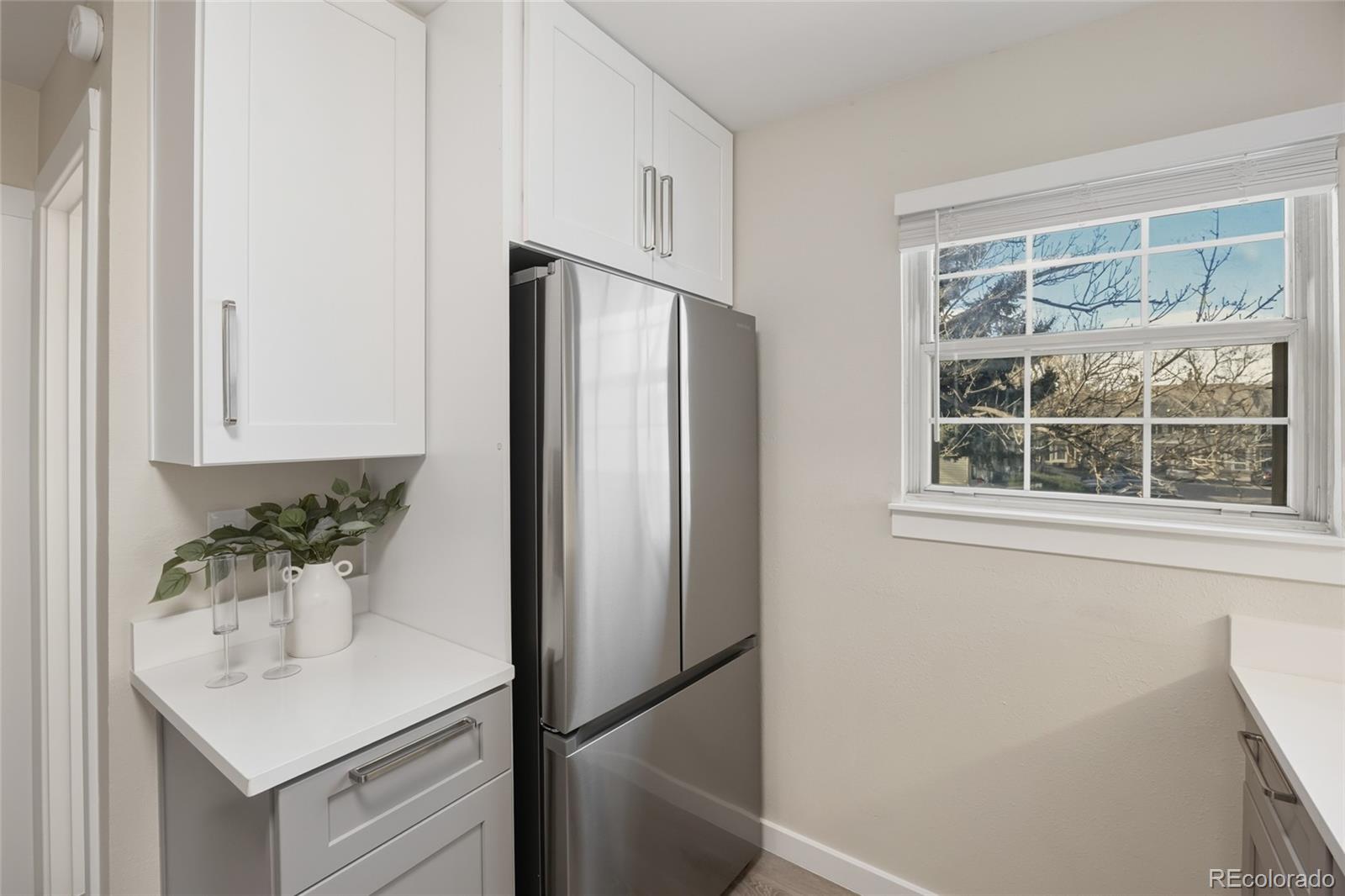 1811 South Quebec Way, Unit 82 Denver, CO 80231 - Photo 13 of 35 a bathroom with a sink and a mirror
