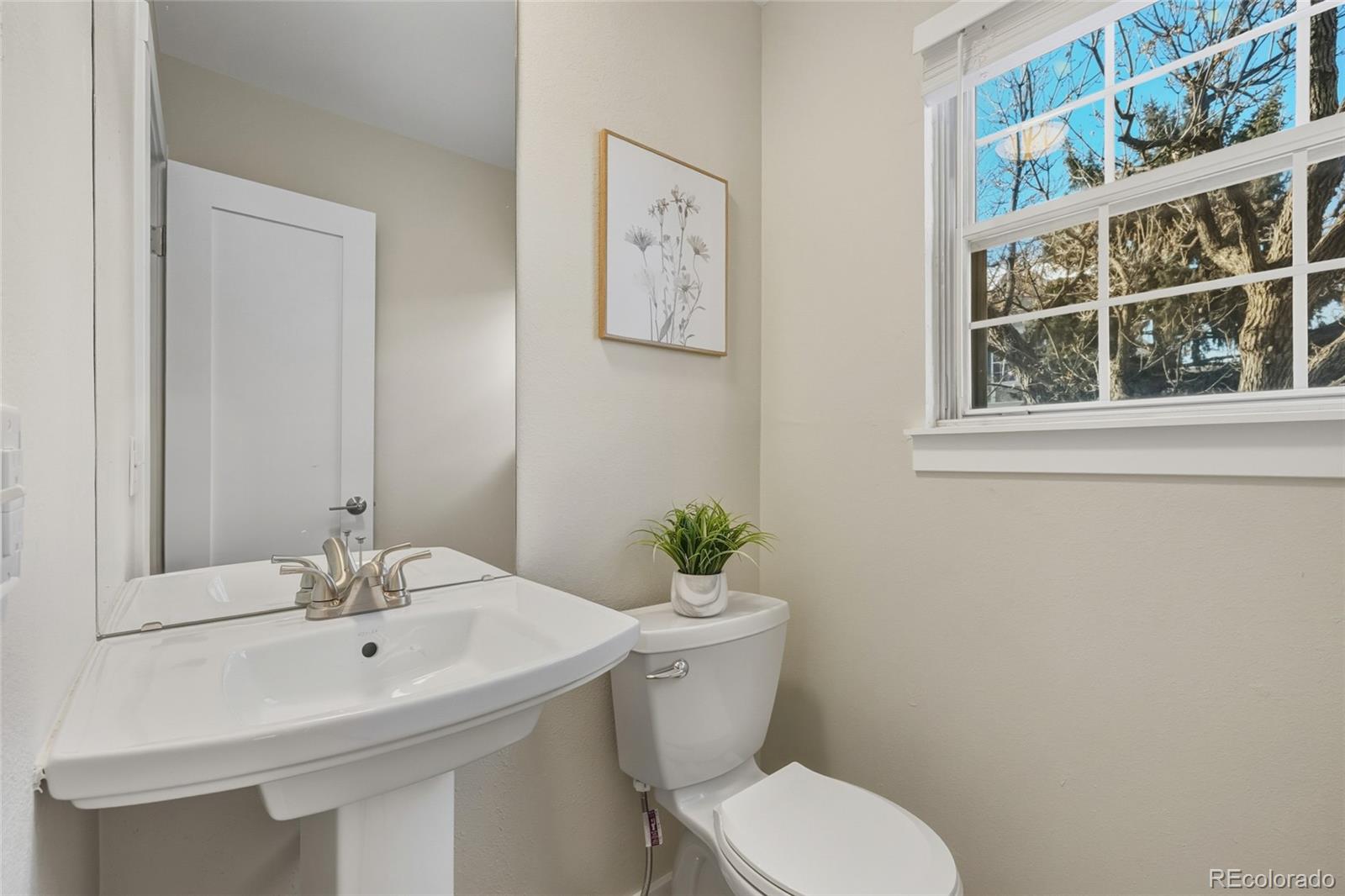 1811 South Quebec Way, Unit 82 Denver, CO 80231 - Photo 15 of 35 a bathroom with a sink mirror and toilet