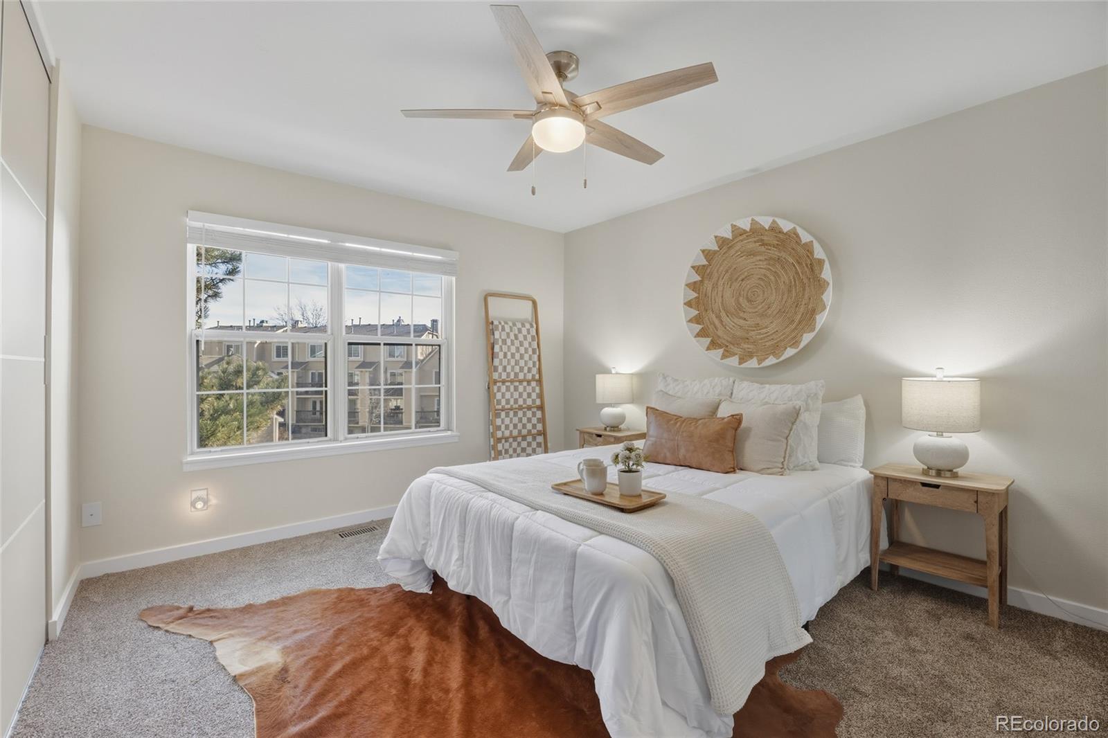 1811 South Quebec Way, Unit 82 Denver, CO 80231 - Photo 17 of 35 a bedroom with a bed and a large window