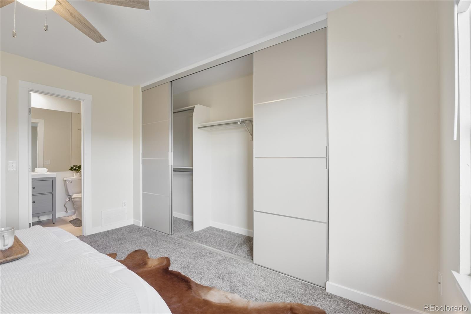 1811 South Quebec Way, Unit 82 Denver, CO 80231 - Photo 20 of 35 a bedroom with a bed and a cabinets