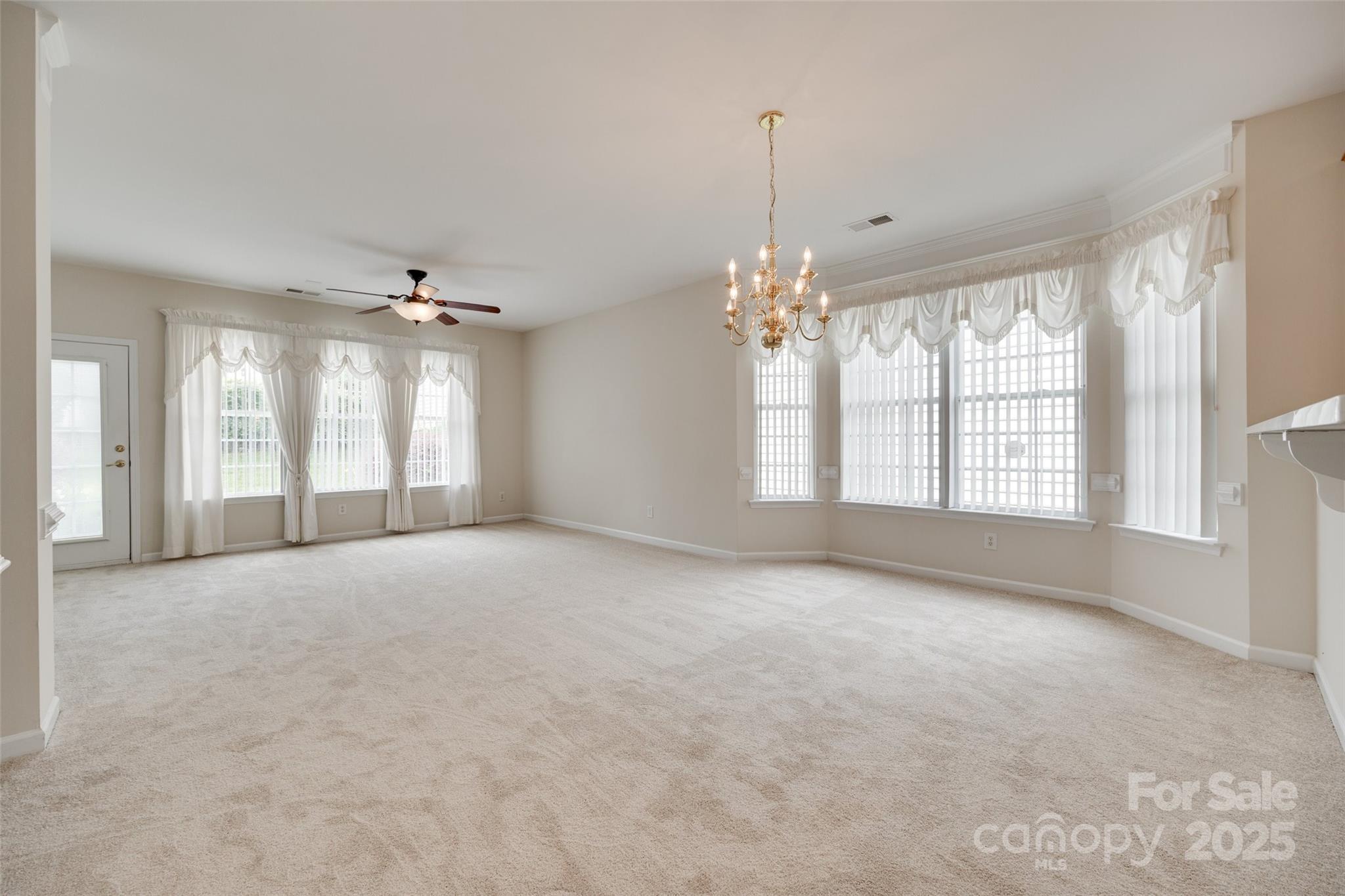 422 Garnet Court Fort Mill, SC 29708 - Photo 11 of 45 a view of an empty room with chandelier and window