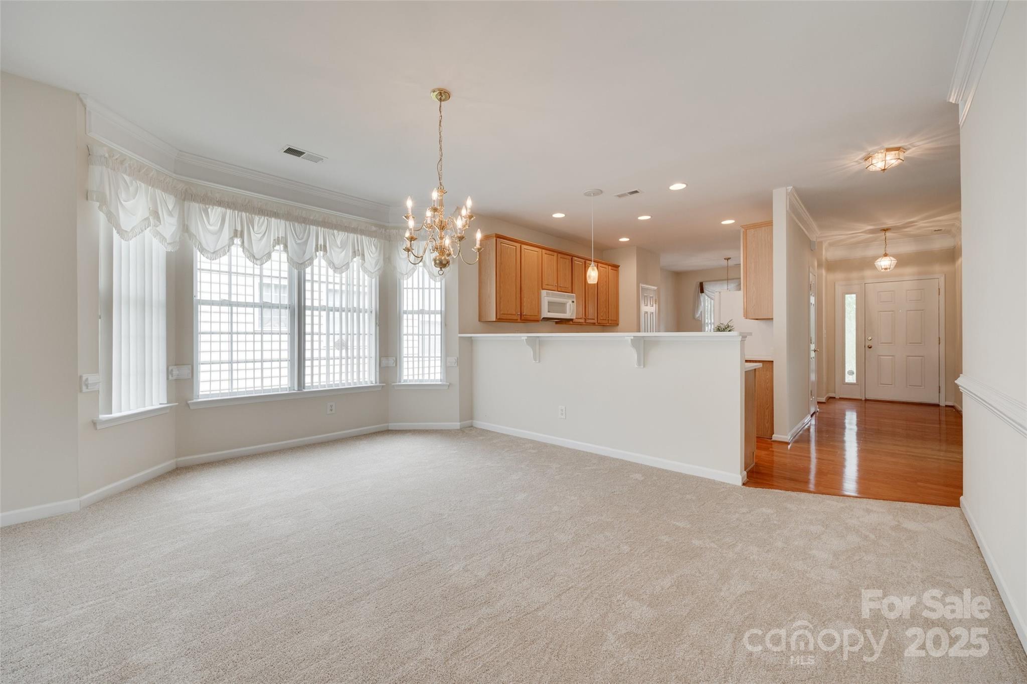 422 Garnet Court Fort Mill, SC 29708 - Photo 12 of 45 a view of an empty room with kitchen and window