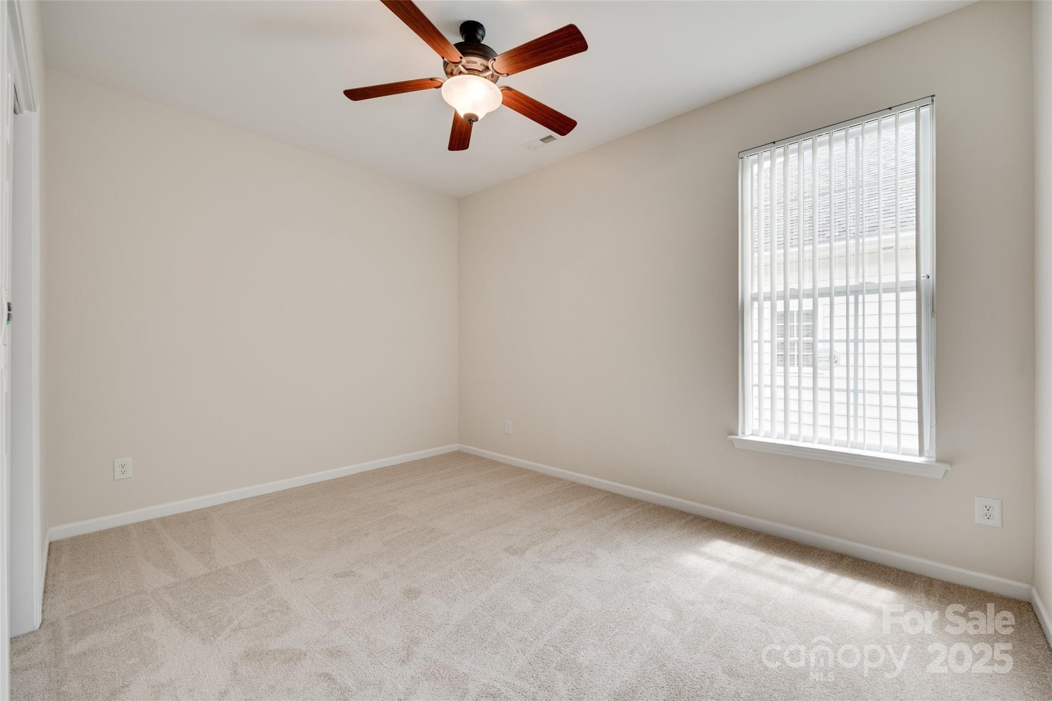 422 Garnet Court Fort Mill, SC 29708 - Photo 16 of 45 an empty room with a window and a fan