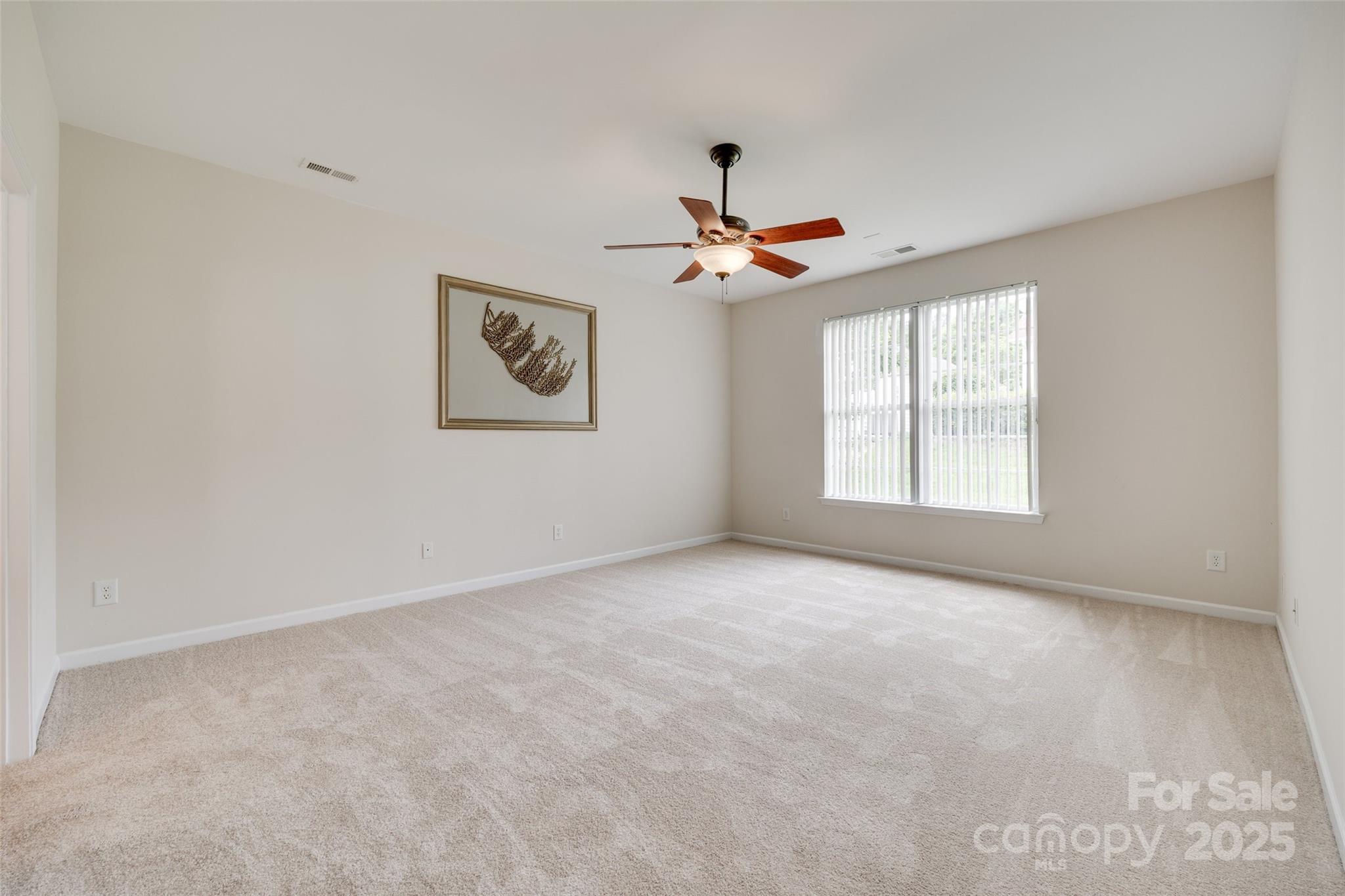 422 Garnet Court Fort Mill, SC 29708 - Photo 19 of 45 an empty room with windows and fan