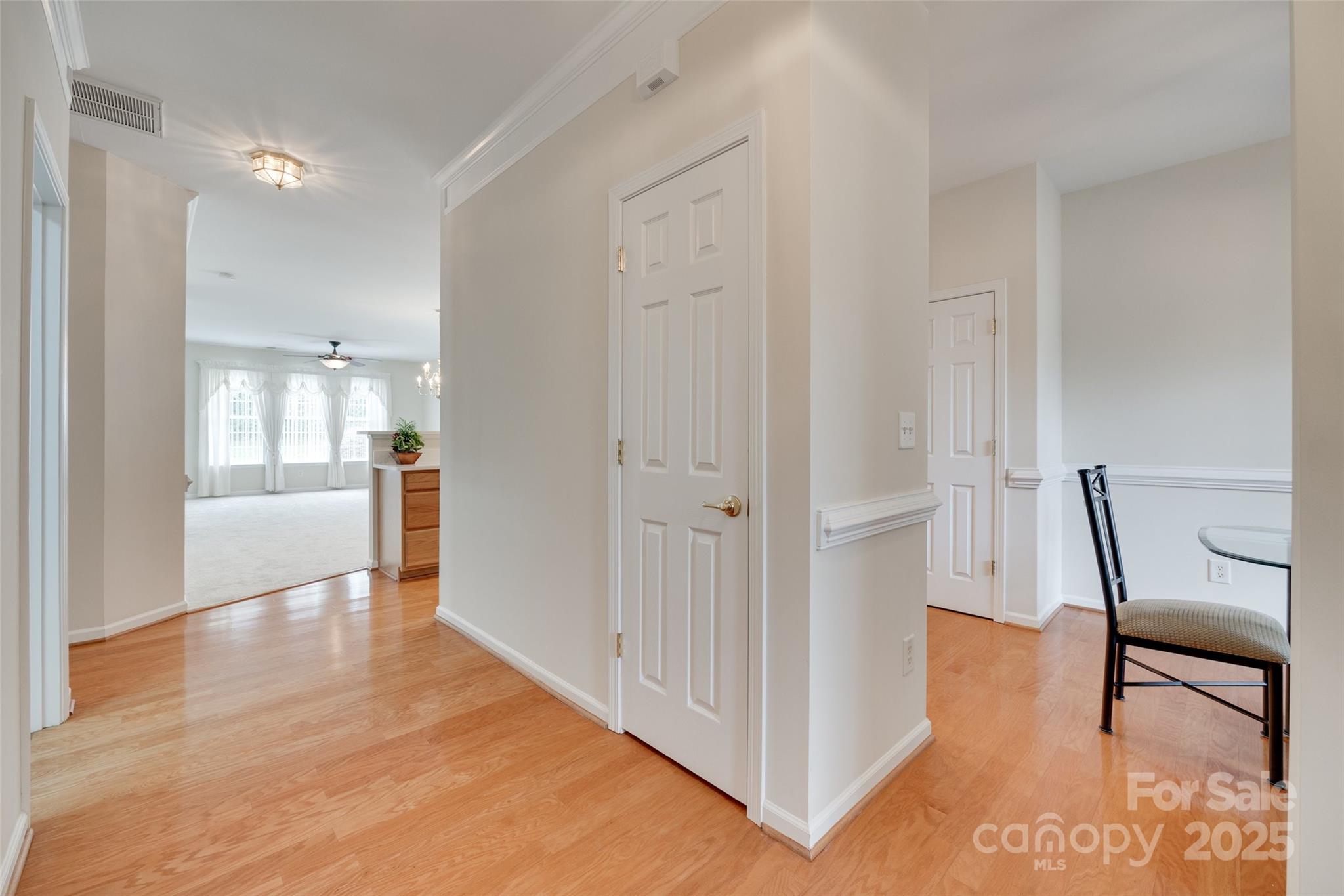 422 Garnet Court Fort Mill, SC 29708 - Photo 4 of 45 a view of a hallway to an empty room and wooden floor