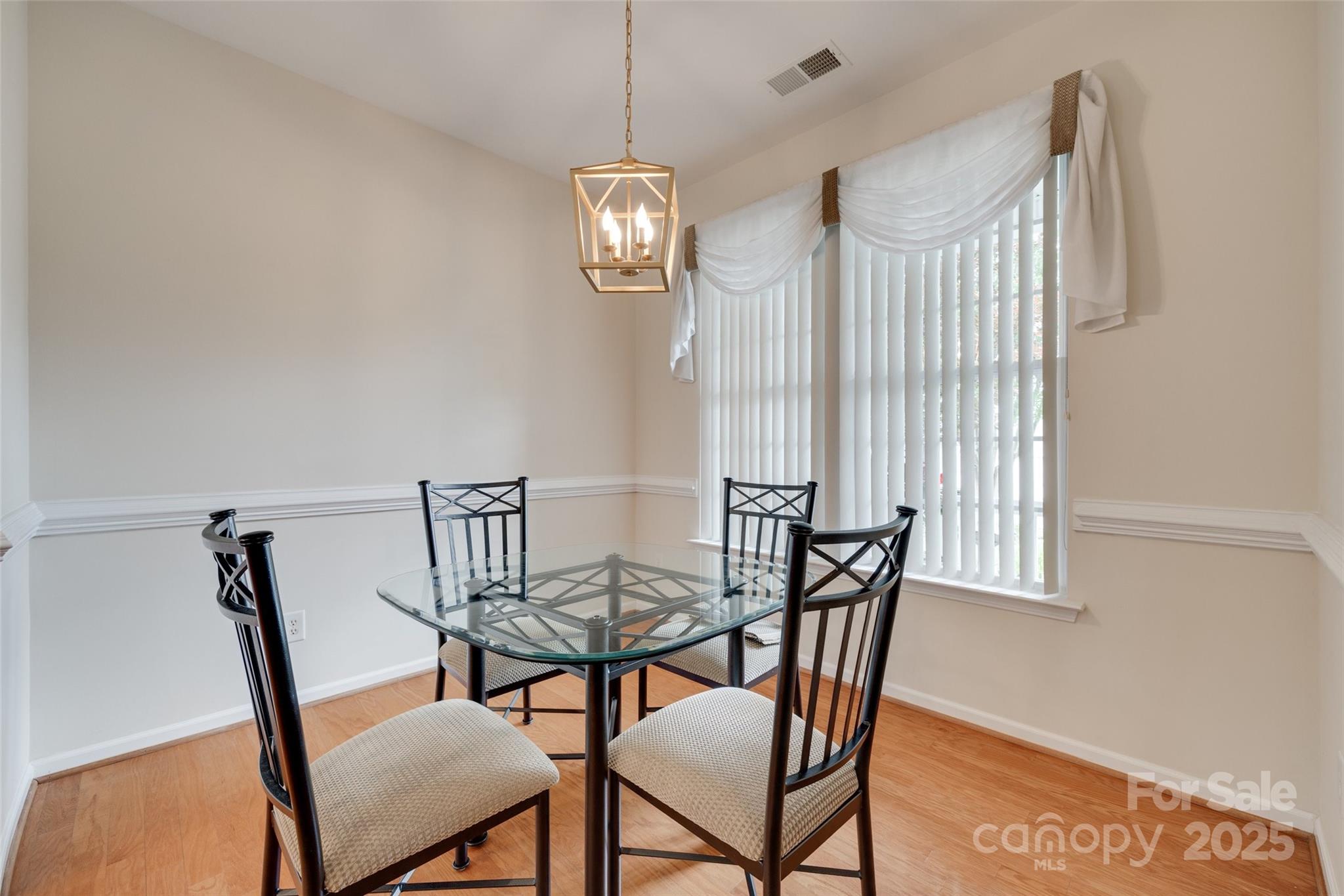 422 Garnet Court Fort Mill, SC 29708 - Photo 5 of 45 a view of a dining room with furniture window and wooden floor