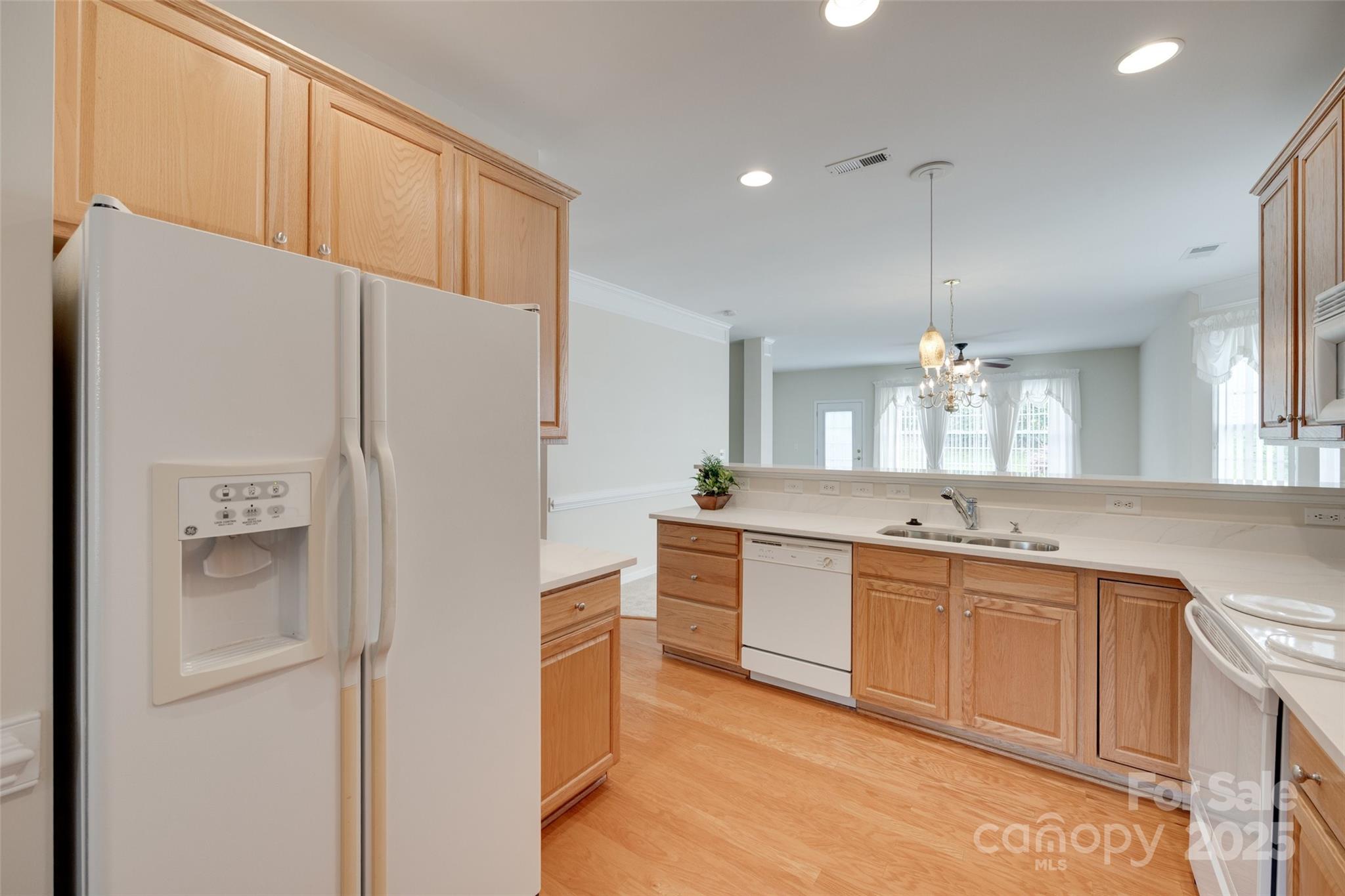 422 Garnet Court Fort Mill, SC 29708 - Photo 8 of 45 a kitchen with white cabinets and white appliances