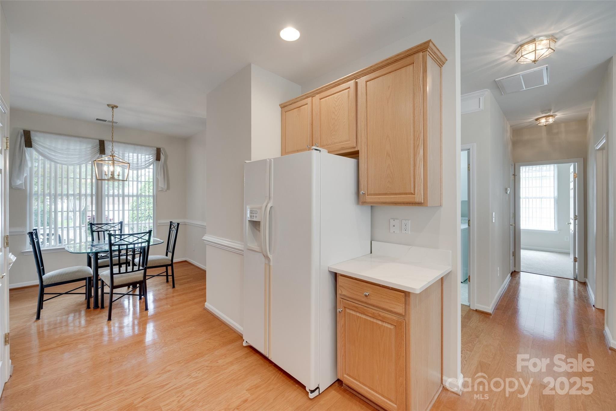 422 Garnet Court Fort Mill, SC 29708 - Photo 9 of 45 a kitchen with stainless steel appliances granite countertop a refrigerator a stove a dining table and chairs with wooden floor