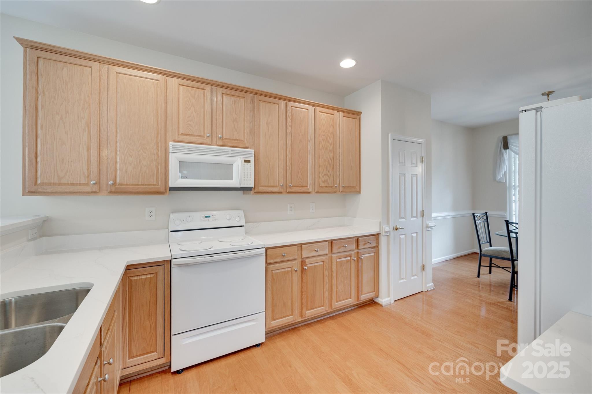 422 Garnet Court Fort Mill, SC 29708 - Photo 10 of 45 a kitchen with a refrigerator sink and cabinets