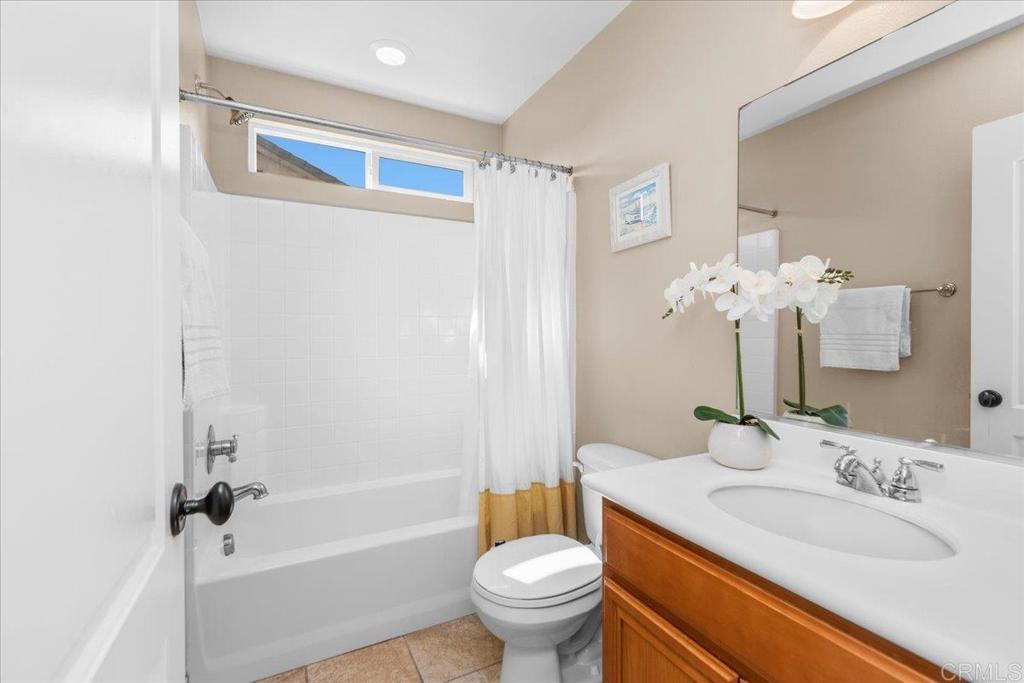 838 Luminara Way San Marcos, CA 92078 - Photo 44 of 54 a bathroom with a sink a toilet and a mirror