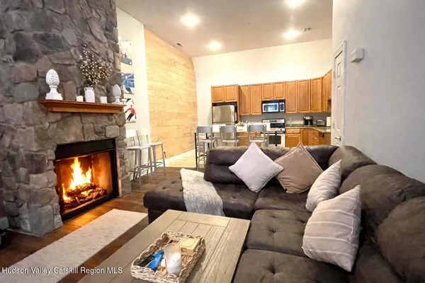 a kitchen with stainless steel appliances kitchen island granite countertop a stove top oven a sink a dining table and chairs