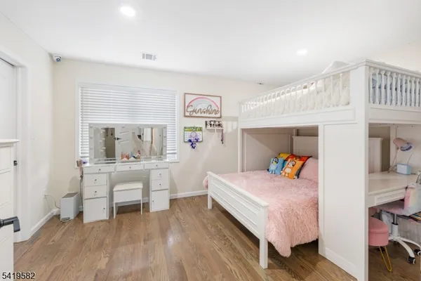 a bedroom with a bed and a desk