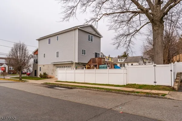 a front view of a house with a yard and trees