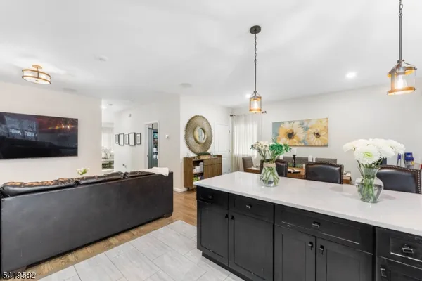 a living room with granite countertop furniture a flat screen tv and a window