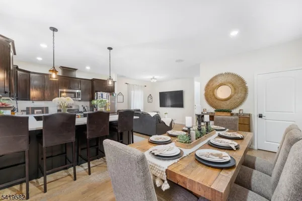 a living room with lots of furniture and kitchen view