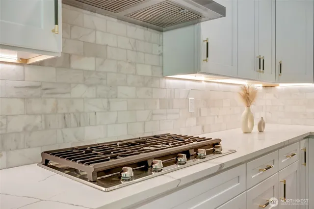 a stove top oven sitting inside of a kitchen