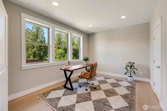 a workspace room with furniture and window