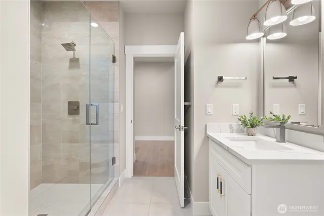 a bathroom with a shower sink and mirror
