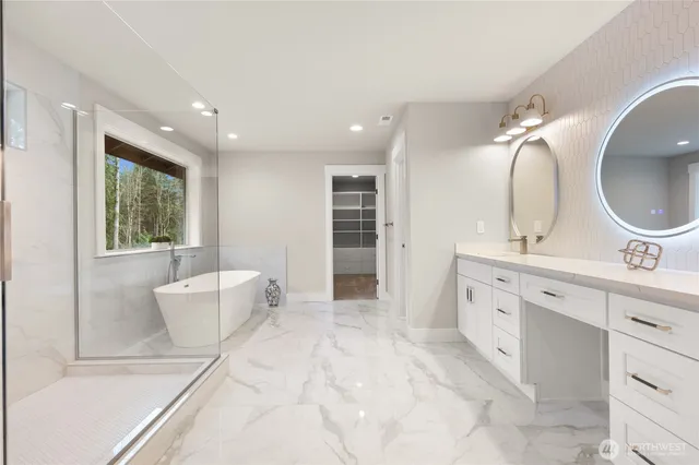 a spacious bathroom with a double vanity sink a large mirror and a bathtub