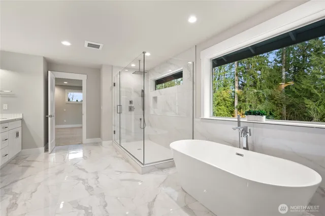 a bathroom with a bathtub and a shower