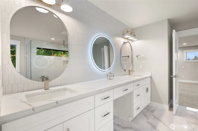 a bathroom with a double vanity sink and a mirror