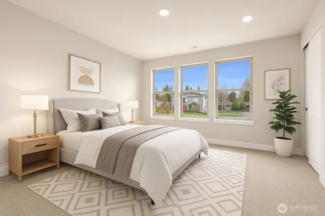 a spacious bedroom with a large bed and a window