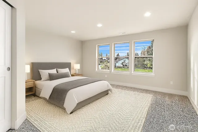 a bedroom with a large bed and a large window