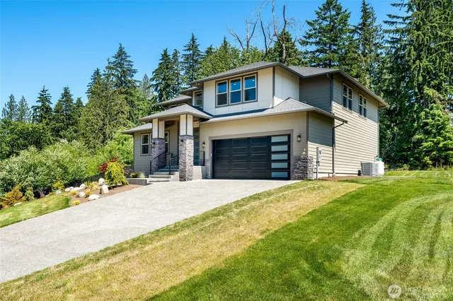 a front view of a house with a yard and garage