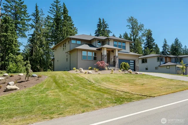 a view of a house with pool and chairs