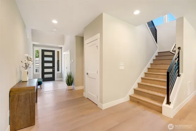 a view of a hallway with seating area and entryway