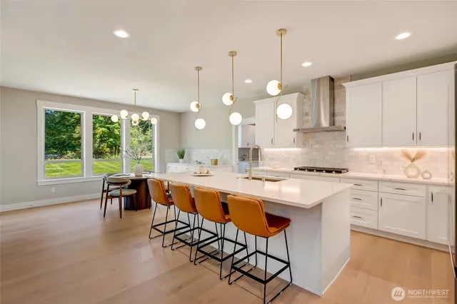a kitchen with stainless steel appliances granite countertop wooden cabinets and a stove