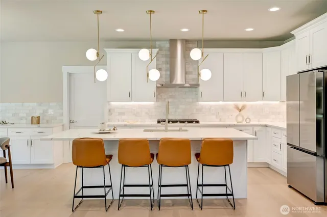 a kitchen with kitchen island granite countertop a table and chairs in it