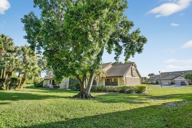 a view of a hallway with dining area and chandelier