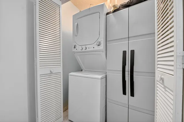 a view of a hallway with wooden floor and a chandelier