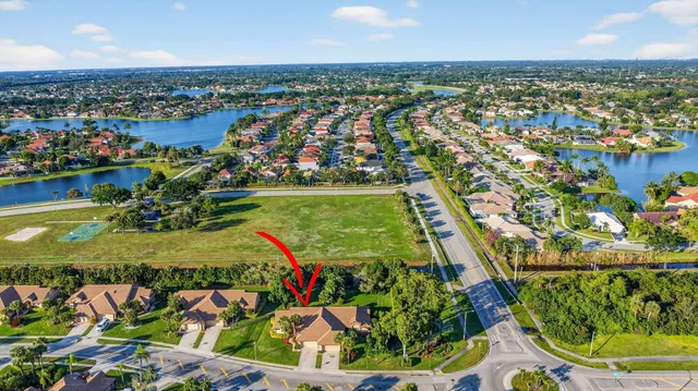 an aerial view of a house with a garden and trees