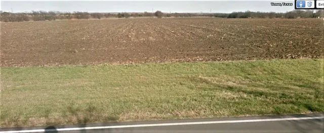 a view of a field with an ocean