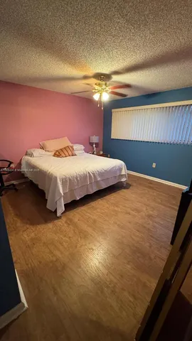 a bed sitting in a bedroom next to a lamp