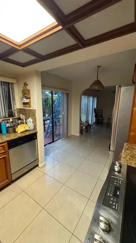 a kitchen with granite countertop a stove a refrigerator and a counter top space