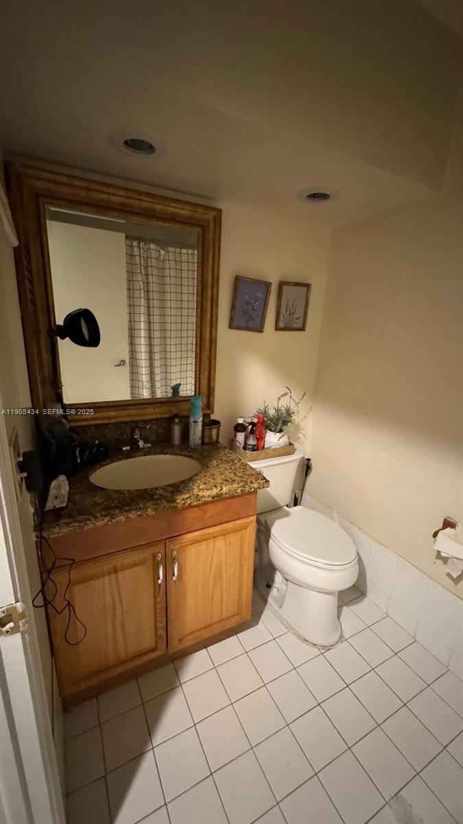 15039 Southwest 89th Ter Road Miami, FL 33196 - Photo 20 of 21 a bathroom with a toilet a sink and mirror