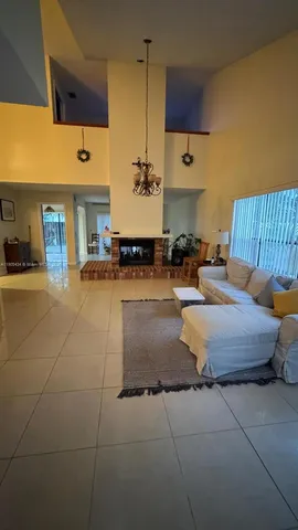 a large bedroom with a bed and table chair