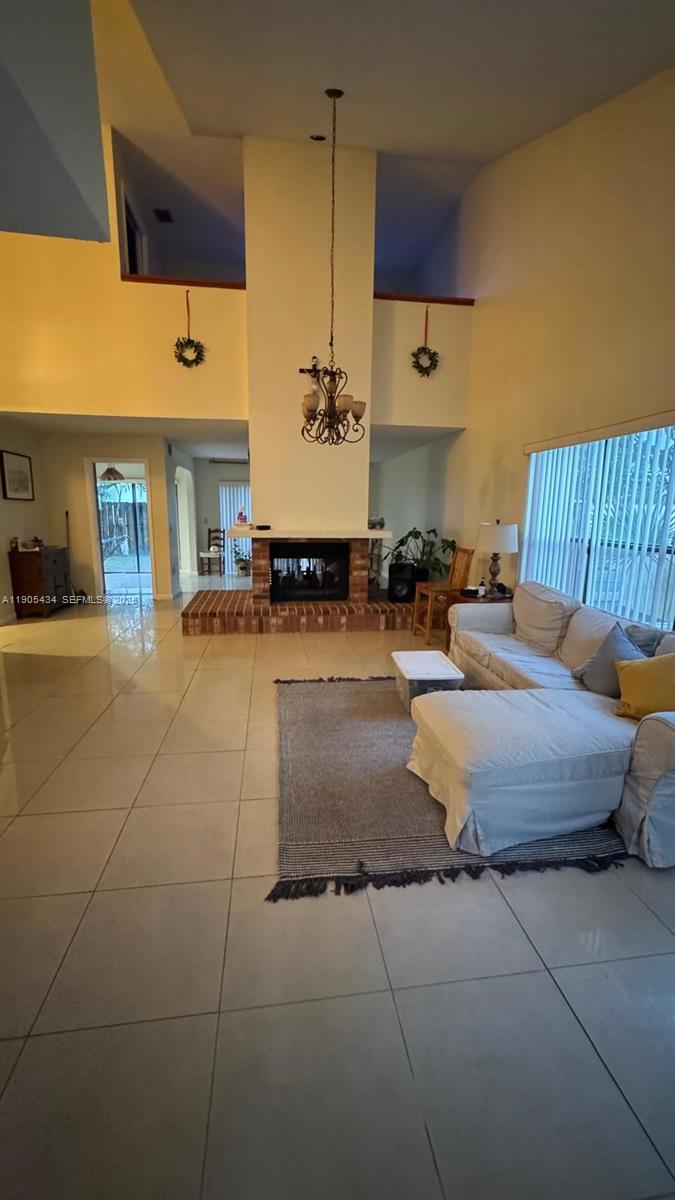 15039 Southwest 89th Ter Road Miami, FL 33196 - Photo 6 of 21 a large bedroom with a bed and table chair