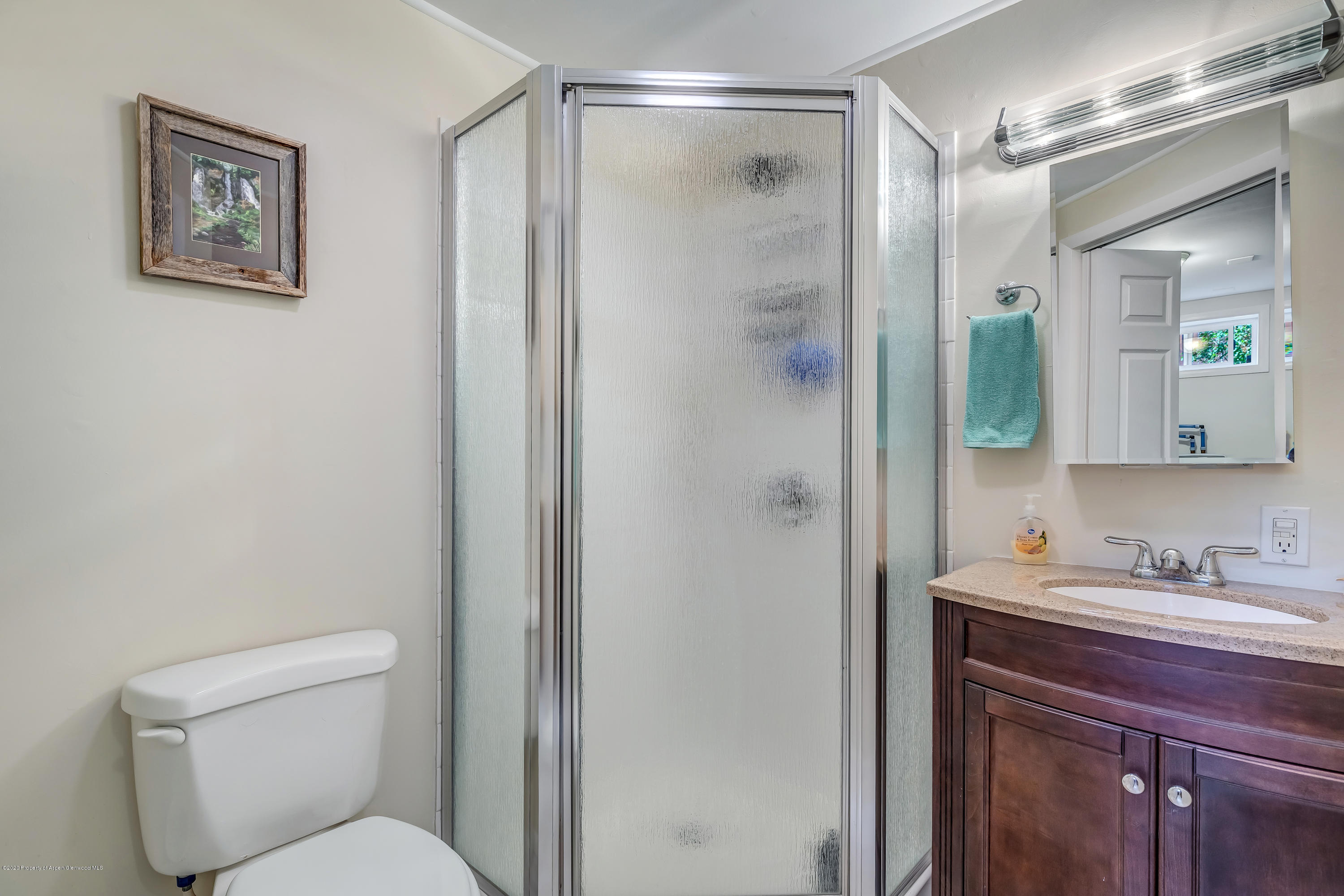 217 Ash Avenue Rifle, CO 81650 - Photo 12 of 25 a bathroom with a toilet sink and shower