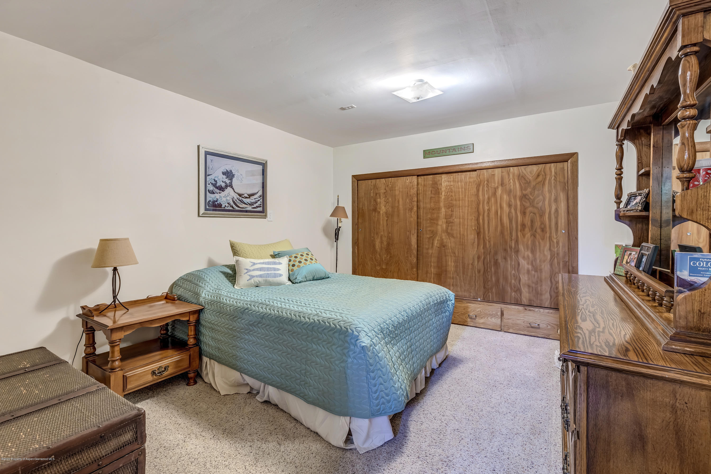 217 Ash Avenue Rifle, CO 81650 - Photo 13 of 25 a bedroom with a bed and a flat screen tv