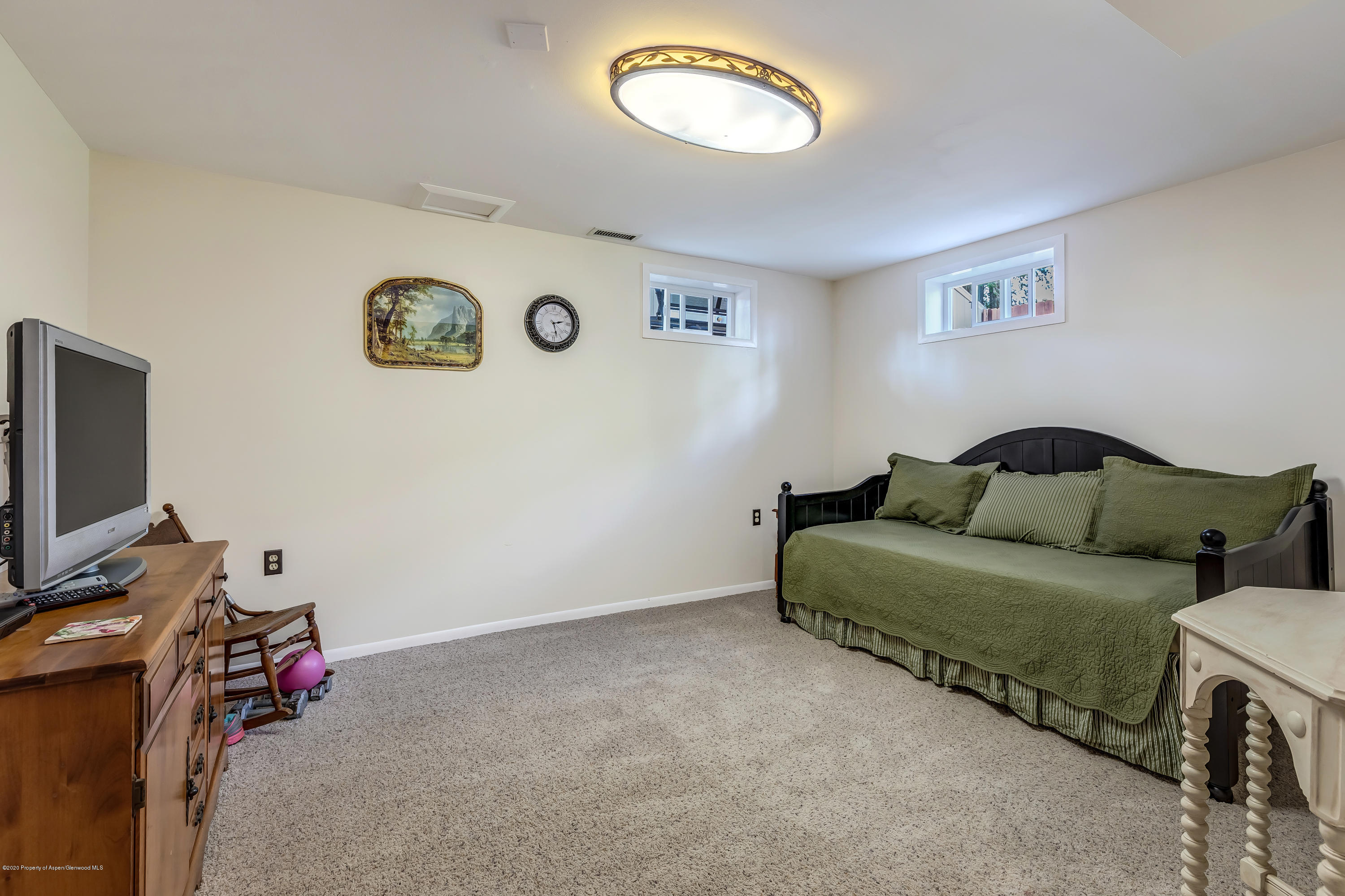 217 Ash Avenue Rifle, CO 81650 - Photo 15 of 25 a living room with furniture and a flat screen tv