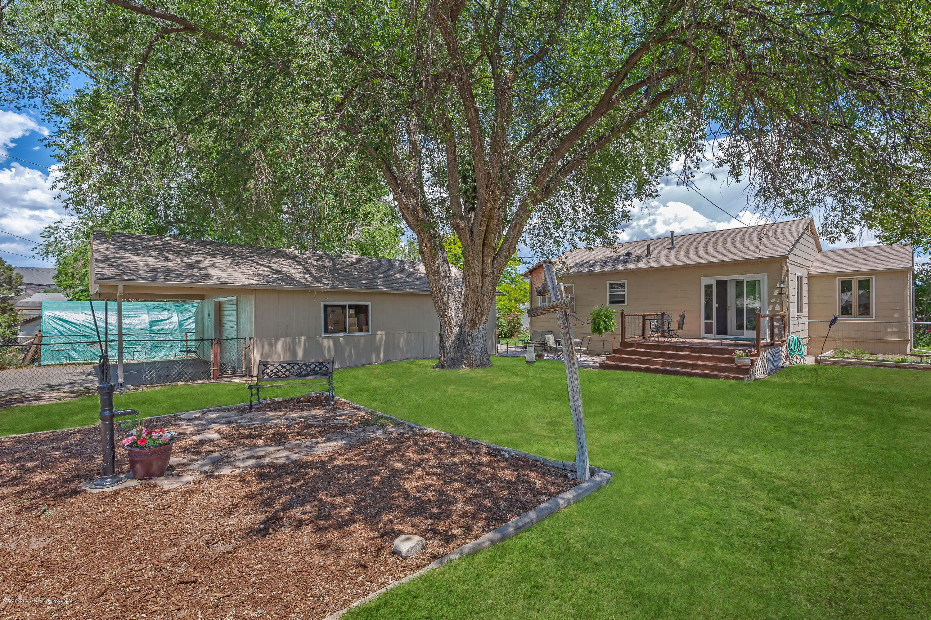 217 Ash Avenue Rifle, CO 81650 - Photo 17 of 25 a view of a house with a yard and a large tree