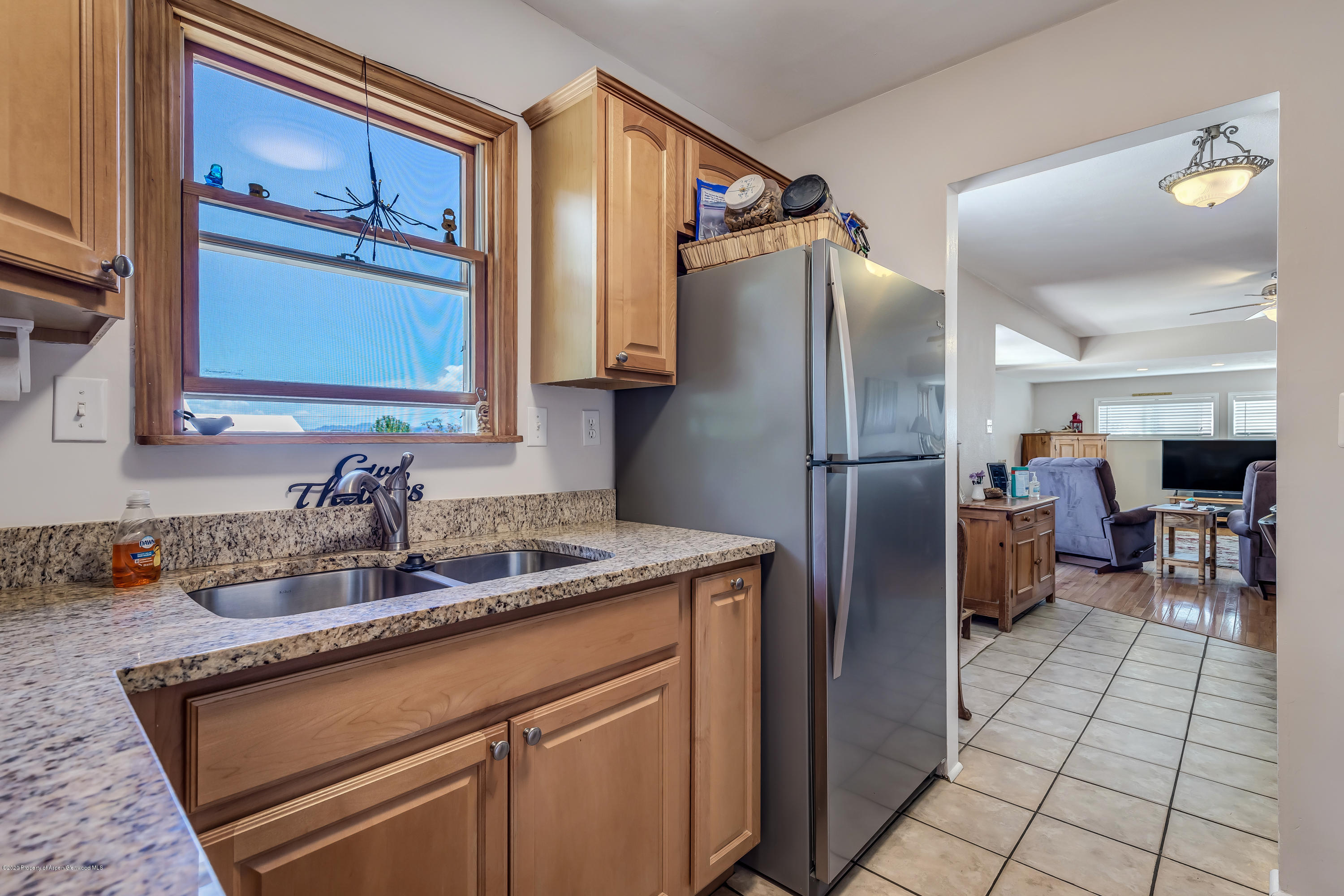 217 Ash Avenue Rifle, CO 81650 - Photo 7 of 25 a kitchen with stainless steel appliances granite countertop a refrigerator and a sink