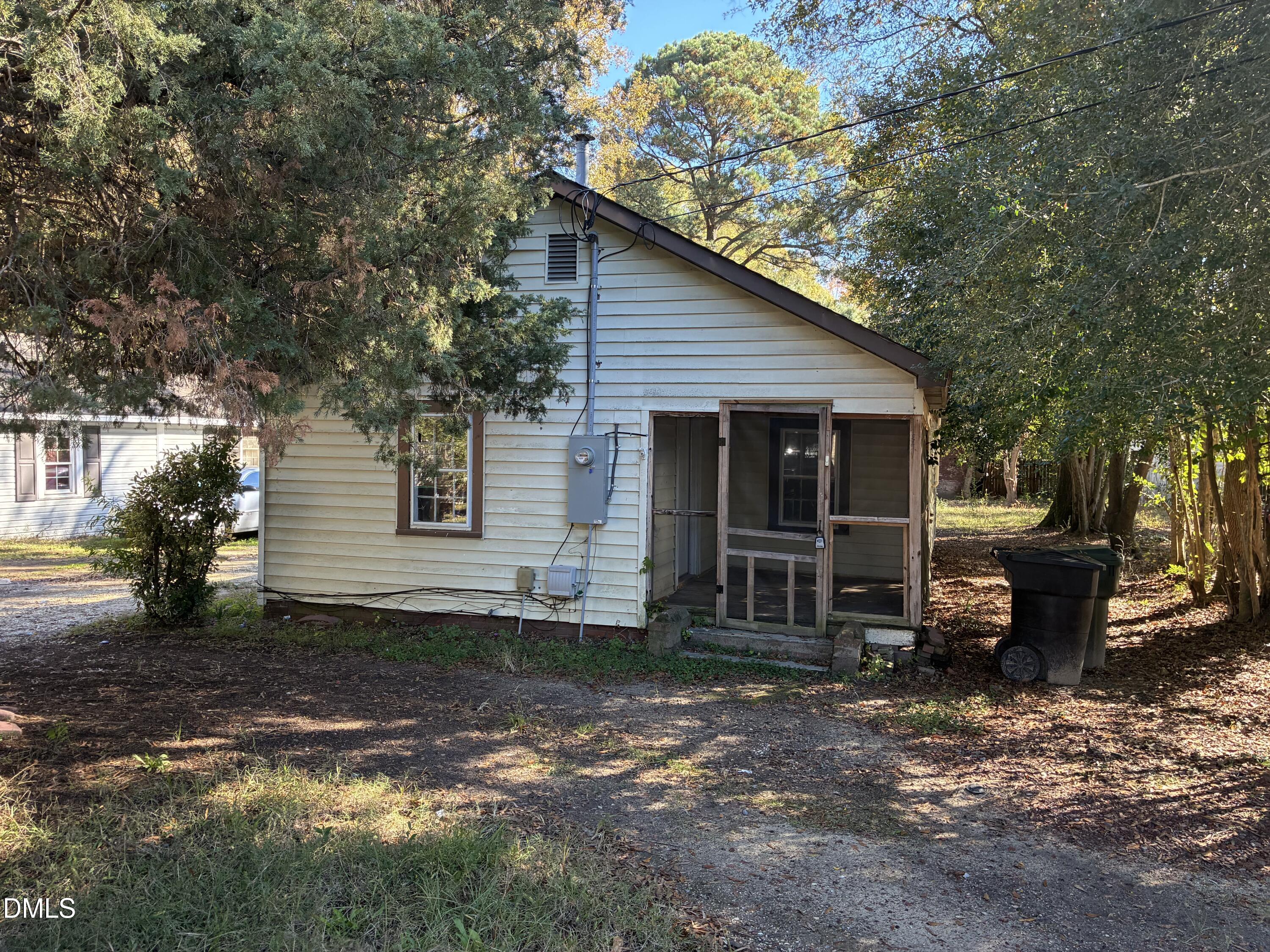 a view of a house with a yard and large tree